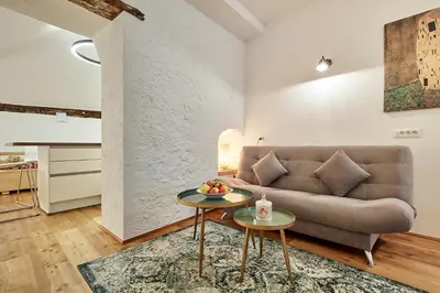 a living room with a couch and a table at KARINA Lauben Lodge in Egna