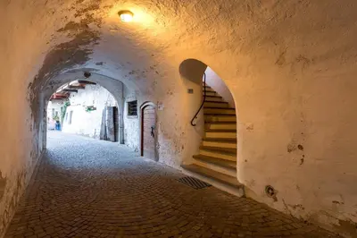 an alley way with stairs in an old building at KARINA Lauben Lodge in Egna