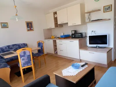 a small living room with a kitchen and a living room at Waldoase in Schenna