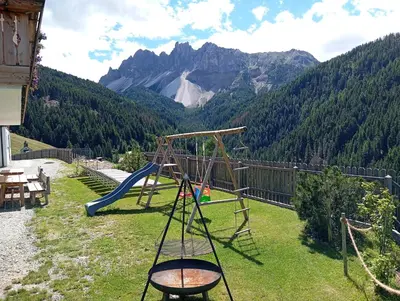 a bedroom with a bed and a large window at Zimmererhof in Bressanone