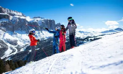 a group of people standing on top of a snow covered mountain at Villa Genziana in Selva di Val Gardena