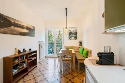 a kitchen with a table and a dining room at Nel cuore di Merano in Merano