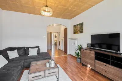 a living room with a couch and a flat screen tv at Nel cuore di Merano in Merano
