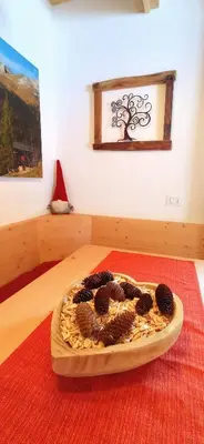 a tray of food sitting on a bed at Tabià sui Prati- Appartamento bilocale in Falcade