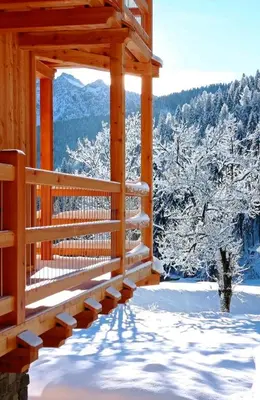 a porch of a cabin in the snow at Tabià sui Prati- Appartamento bilocale in Falcade