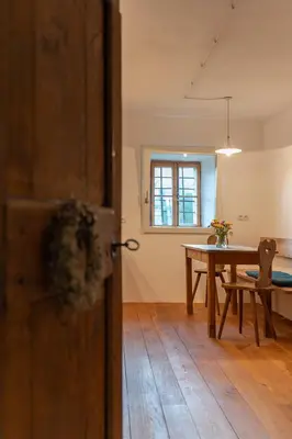 an open door to a room with a table at Bauernhof Hof Unternberg in Magrè allʼ Adige