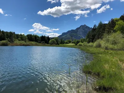a view of a lake with mountains in the background at Bauernhof Hof Unternberg in Magrè allʼ Adige