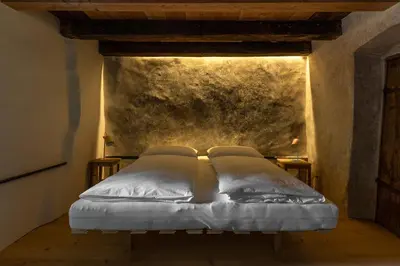 a bed with two pillows on it in a room at Bauernhof Hof Unternberg in Magrè allʼ Adige