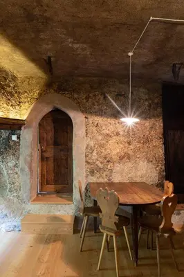 a dining room with a wooden table and chairs at Bauernhof Hof Unternberg in Magrè allʼ Adige