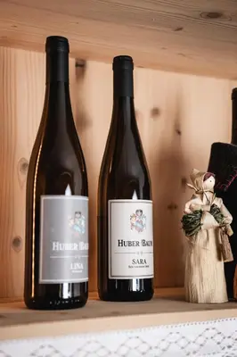 two bottles of wine sitting on a shelf at Huber unterm Baum in Lagundo