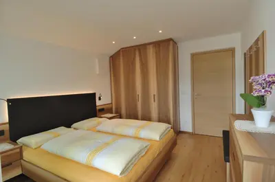 a bedroom with a large bed in a room at Apartments Helga in Castelrotto