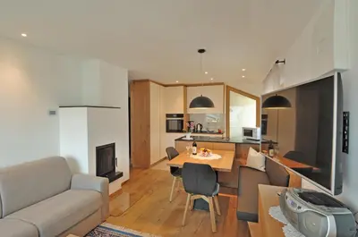 a living room and kitchen with a table and a couch at Apartments Helga in Castelrotto