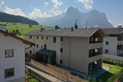 a view of a building with a mountain in the background at Apartments Helga in Castelrotto