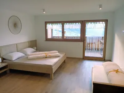 two beds in a room with two windows at Obergereuth Hof 2021 in San Martino