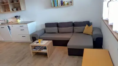 a living room with a couch and a table at Obergereuth Hof 2021 in San Martino