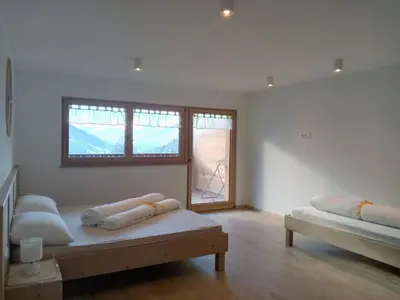 a white room with two beds and a window at Obergereuth Hof 2021 in San Martino