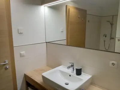 a bathroom with a sink and a mirror at Obergereuth Hof 2021 in San Martino