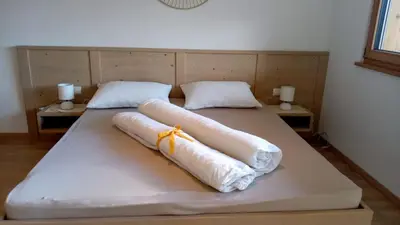 a bed with two white pillows on top of it at Obergereuth Hof 2021 in San Martino