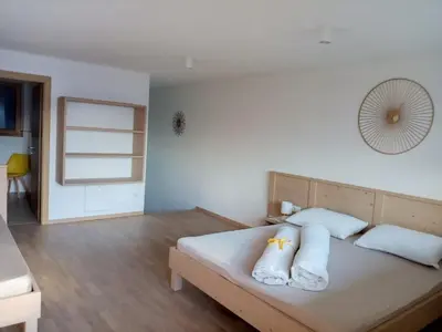 a bedroom with a bed with white sheets and pillows at Obergereuth Hof 2021 in San Martino