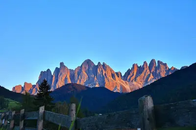 a view of a mountain range at sunset at Proihof in Funes