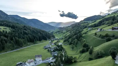 an aerial view of a village in the mountains at Proihof in Funes