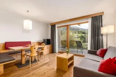 a living room with a couch and a table at Proihof in Funes
