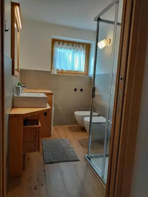 a bathroom with a shower and a sink and a toilet at Tabiá sui Prá - appartamento monolocale Anna in Falcade