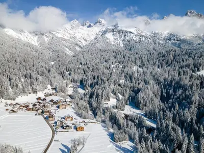 an aerial view of a ski resort with snow covered mountains at Tabiá sui Prá - appartamento monolocale Anna in Falcade