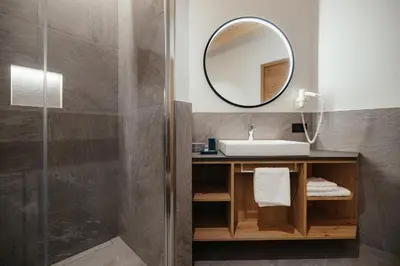a bathroom with a sink and a mirror at Aria de Munt in San Vigilio Di Marebbe