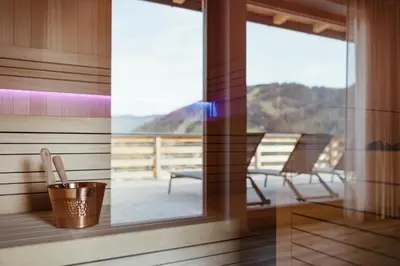 a room with a balcony with a table and chairs at Aria de Munt in San Vigilio Di Marebbe