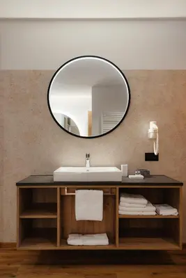 a bathroom with a sink and a mirror at Aria de Munt in San Vigilio Di Marebbe