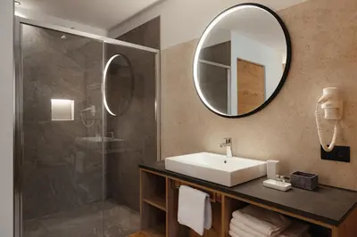 a bathroom with a sink and a shower at Aria de Munt in San Vigilio Di Marebbe