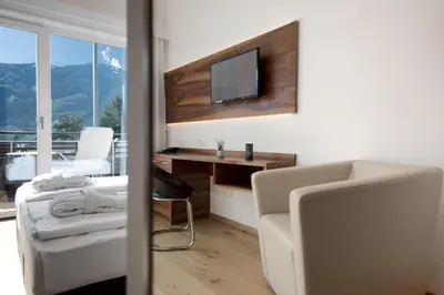 a large kitchen with wooden cabinets and counters at Hotel Ladurner in Merano