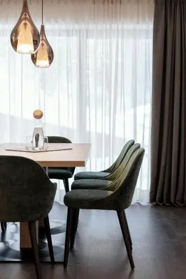 a dining room with a table and two chairs at Chalet Miriam in Selva di Val Gardena