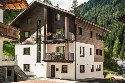 an apartment building with balconies on a mountain at Chalet Miriam in Selva di Val Gardena