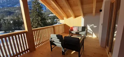 a balcony with two chairs and a view of the mountains at Editlodge 