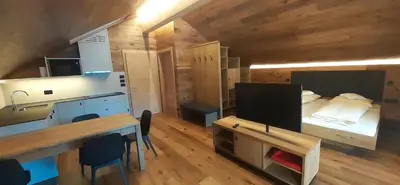 a room with a bed and a desk and a table at Editlodge 