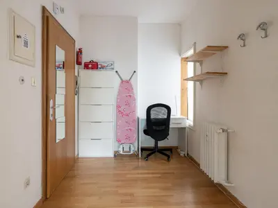 a bedroom with a desk and a chair in a room at Merano-biz in Merano