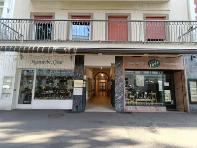 a store front of a building with a balcony at Merano-biz in Merano