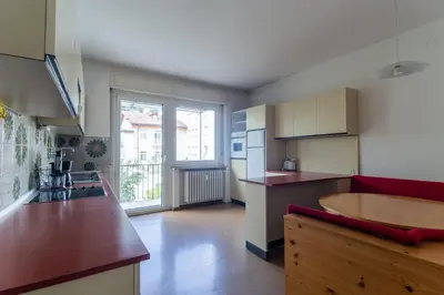 a kitchen with a table and a counter top at Merano-biz in Merano