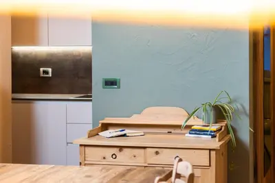 a kitchen with a wooden table with a potted plant at Ciasa Buro - Gimel in Moena