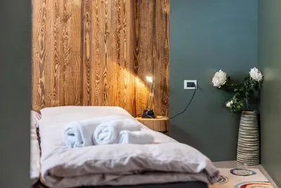a bedroom with a bed with two face towels at Ciasa Buro - Gimel in Moena