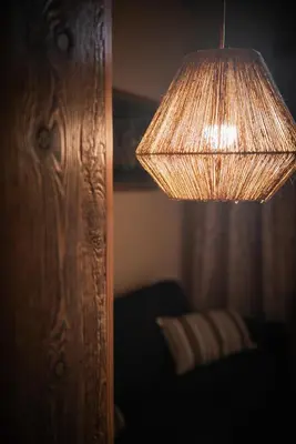 a close up of a lamp with a lamp shade at Ciasa Buro - Gimel in Moena