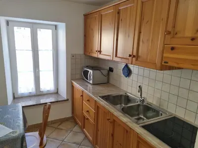 a kitchen with a sink and a microwave at CHENINA in Canazei