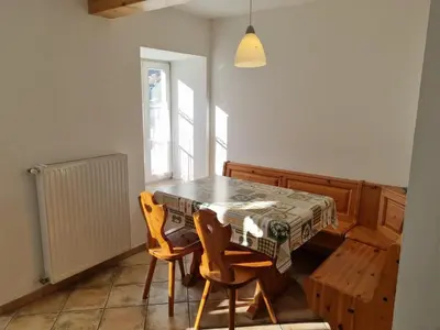 a dining room with a table and two chairs at CHENINA in Canazei