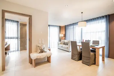 a living room with a table and a dining room at Erika Suites & Lofts in Stanghe