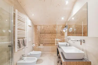a bathroom with two sinks and two toilets at Erika Suites & Lofts in Stanghe