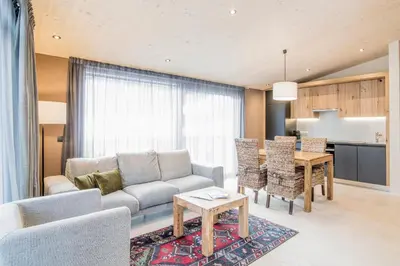 a living room with a couch and a table at Erika Suites & Lofts in Stanghe