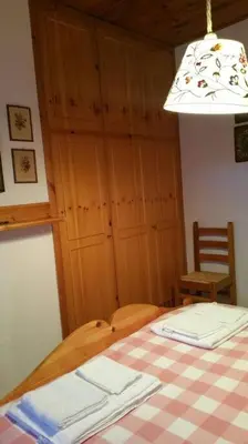 a room with a table with a checkered table cloth on it at MirarMonti nel cuore di Pozza con i tuoi animali in Pozza di Fassa