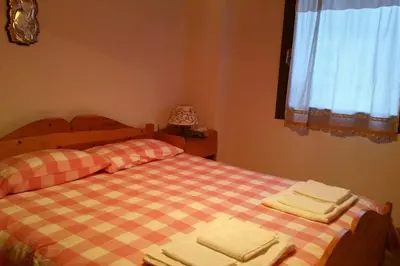 a bedroom with two beds with towels on them at MirarMonti nel cuore di Pozza con i tuoi animali in Pozza di Fassa